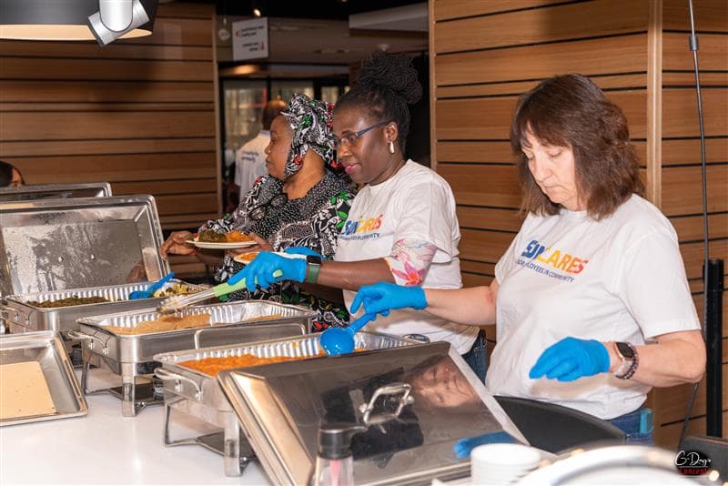 People wearing SunCares shirts serving food