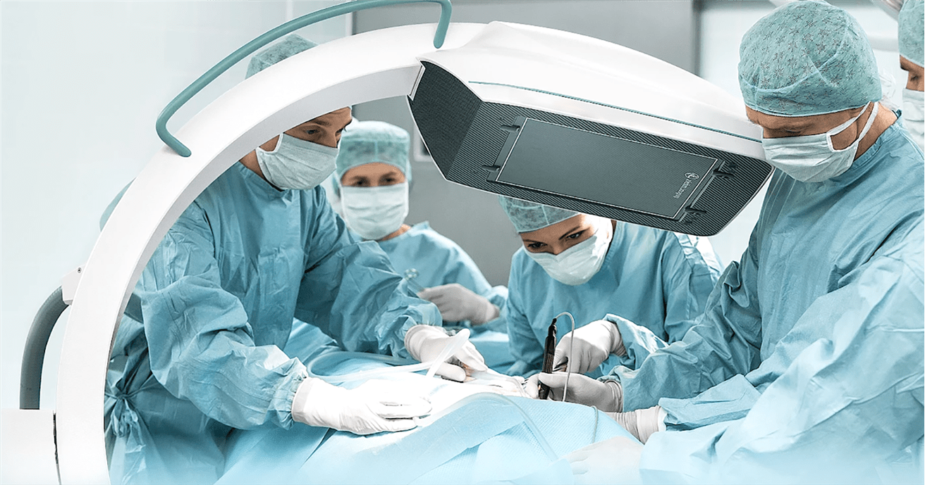 Physicians perform surgery using the C-ARM imaging system. 