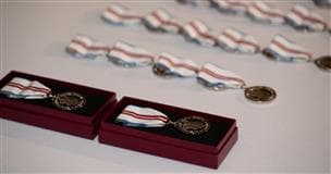 Shiny medals are displayed in a row.