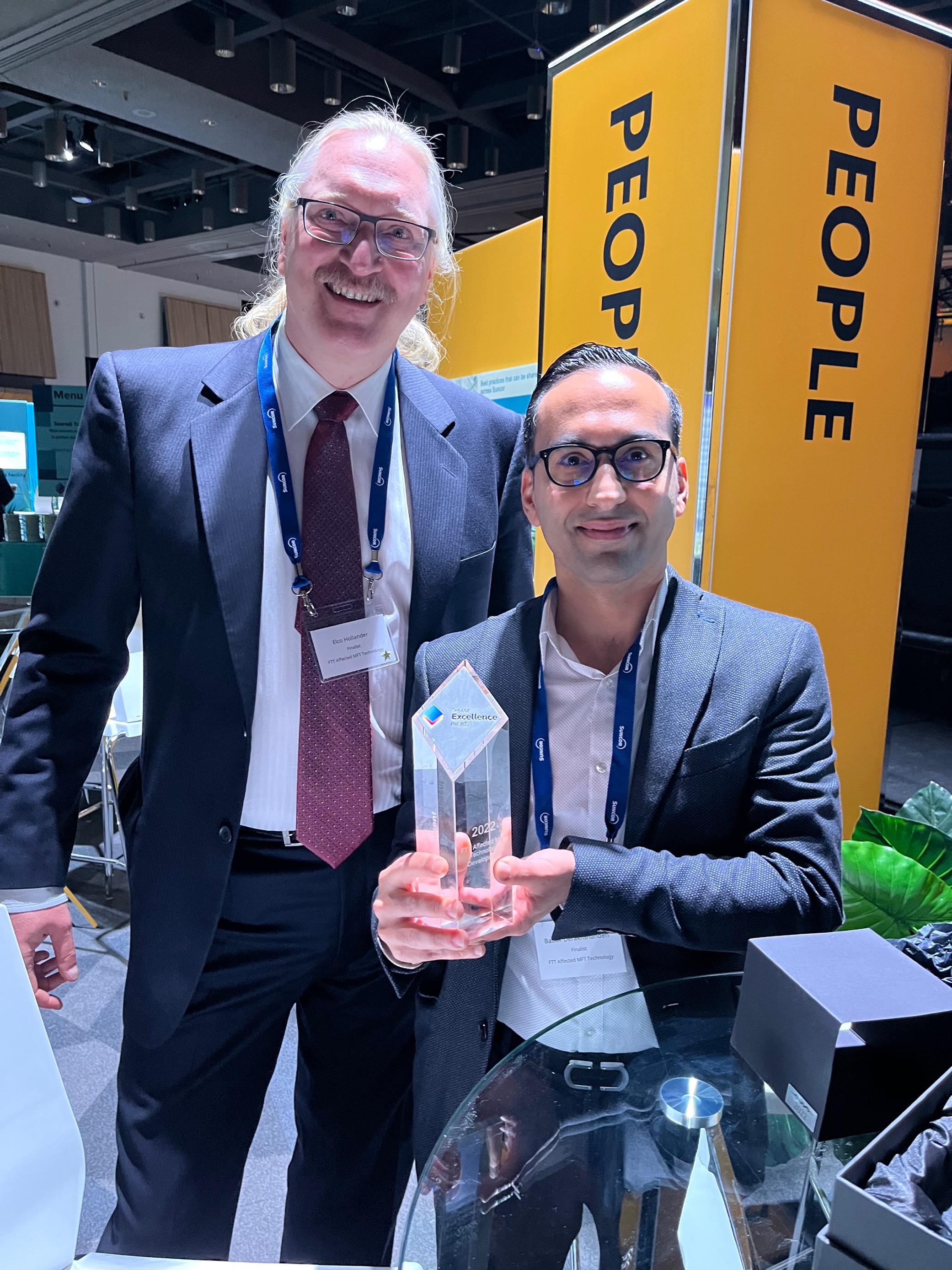 Elco Hollander and Babak Derakshandh pose with their Suncor Excellence Award.