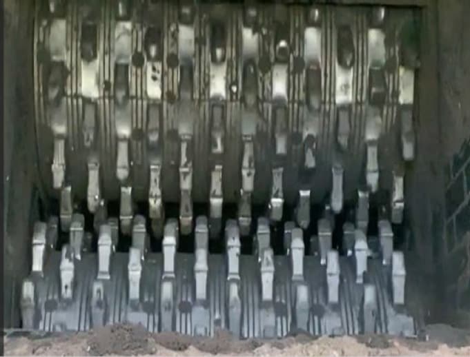 A set of steel rollers with spikes that look like teeth.