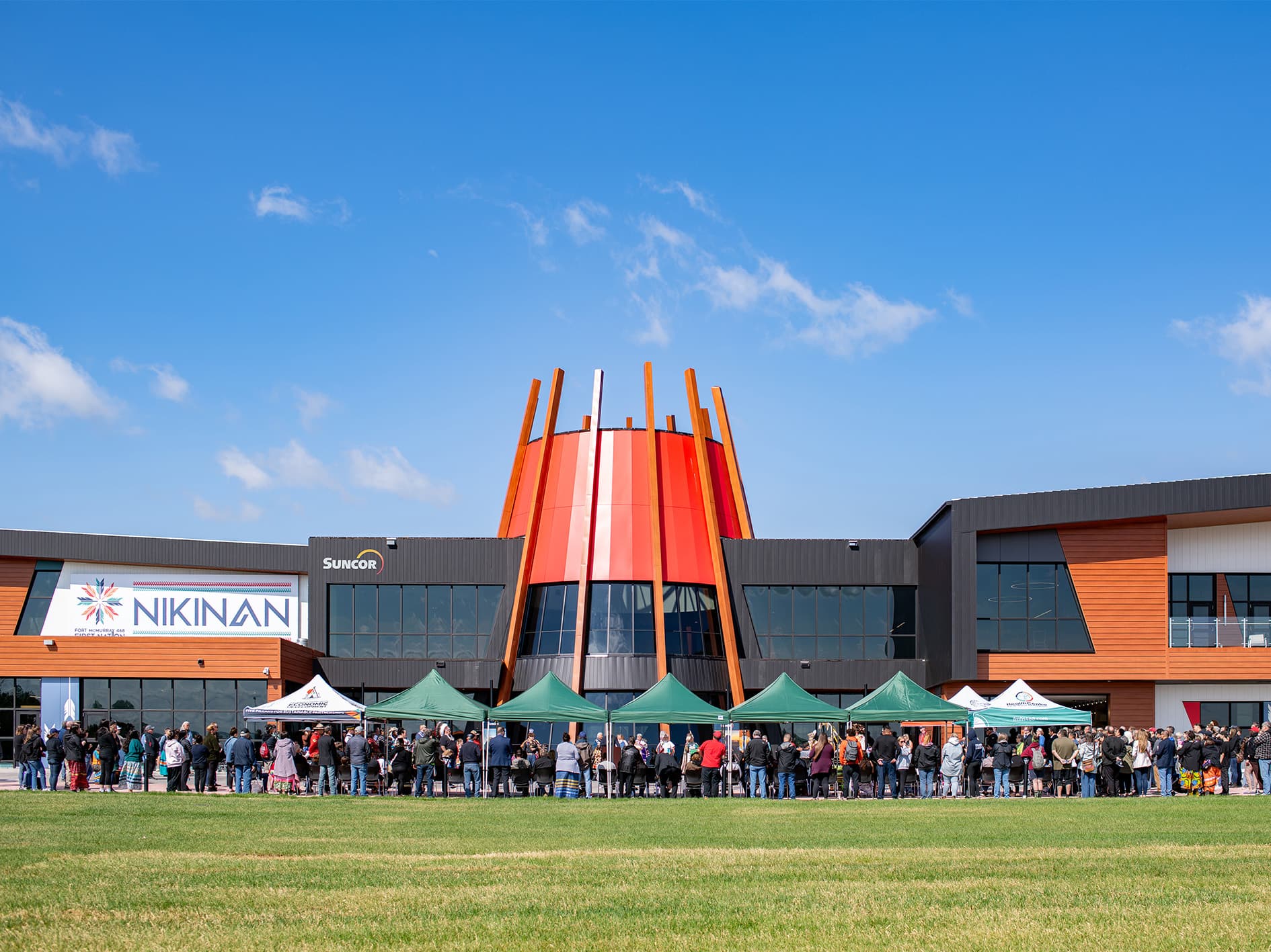 Crowds of people stand outside the Nikinan Community Centre.