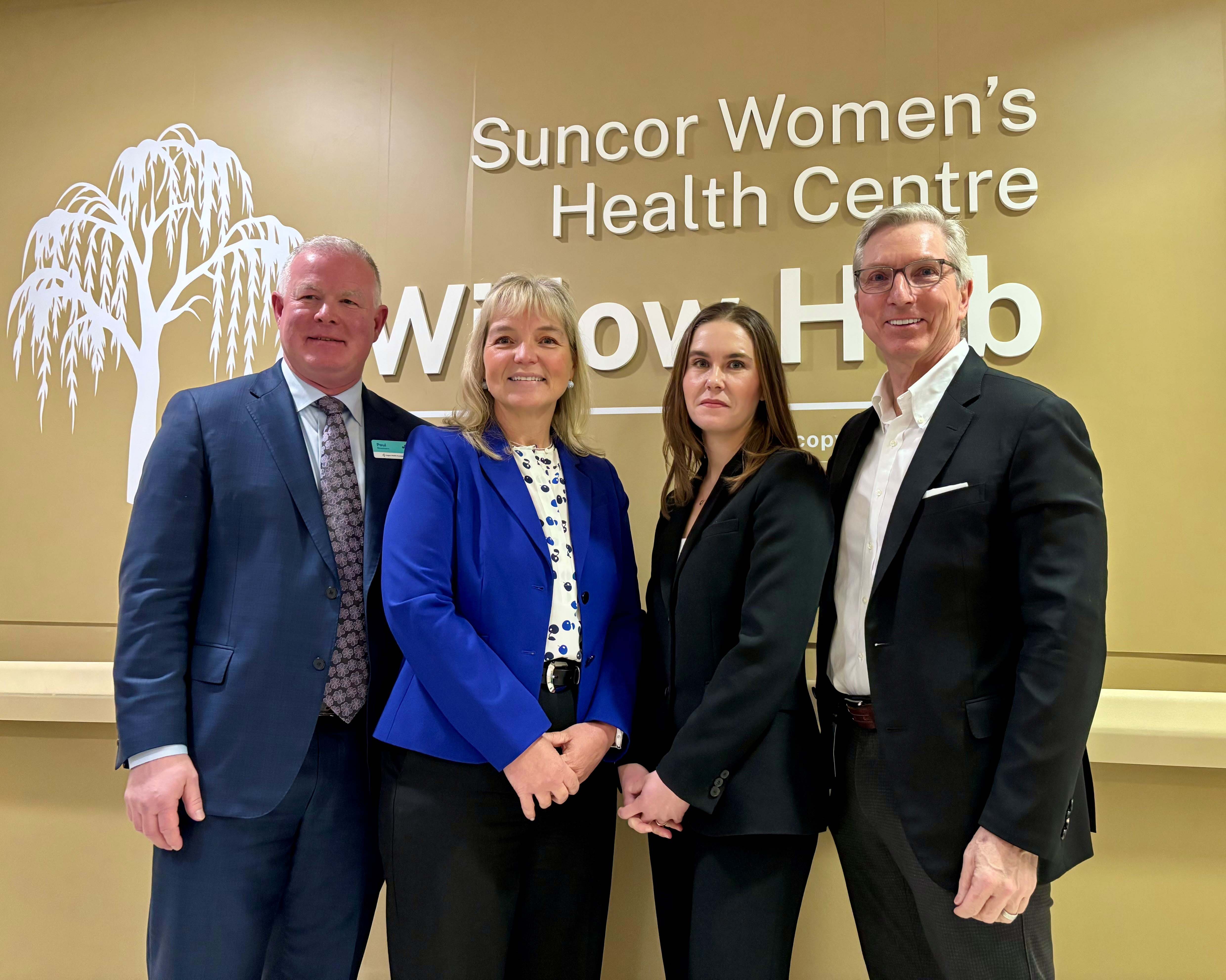 Leaders from Suncor Energy,  the Calgary Health Foundation and Alberta Health Services pose for a photo. The wall behind them reads, “Suncor Women’s Health Centre: Willow Hub".