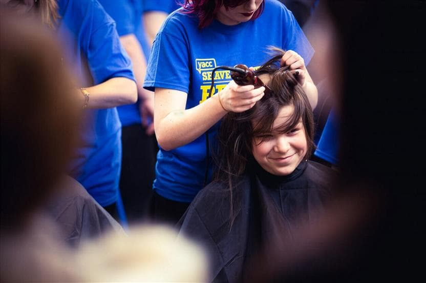 A close-up of a teenager having her head shaved at an Energy Shave for the Brave event in Newfoundland. 