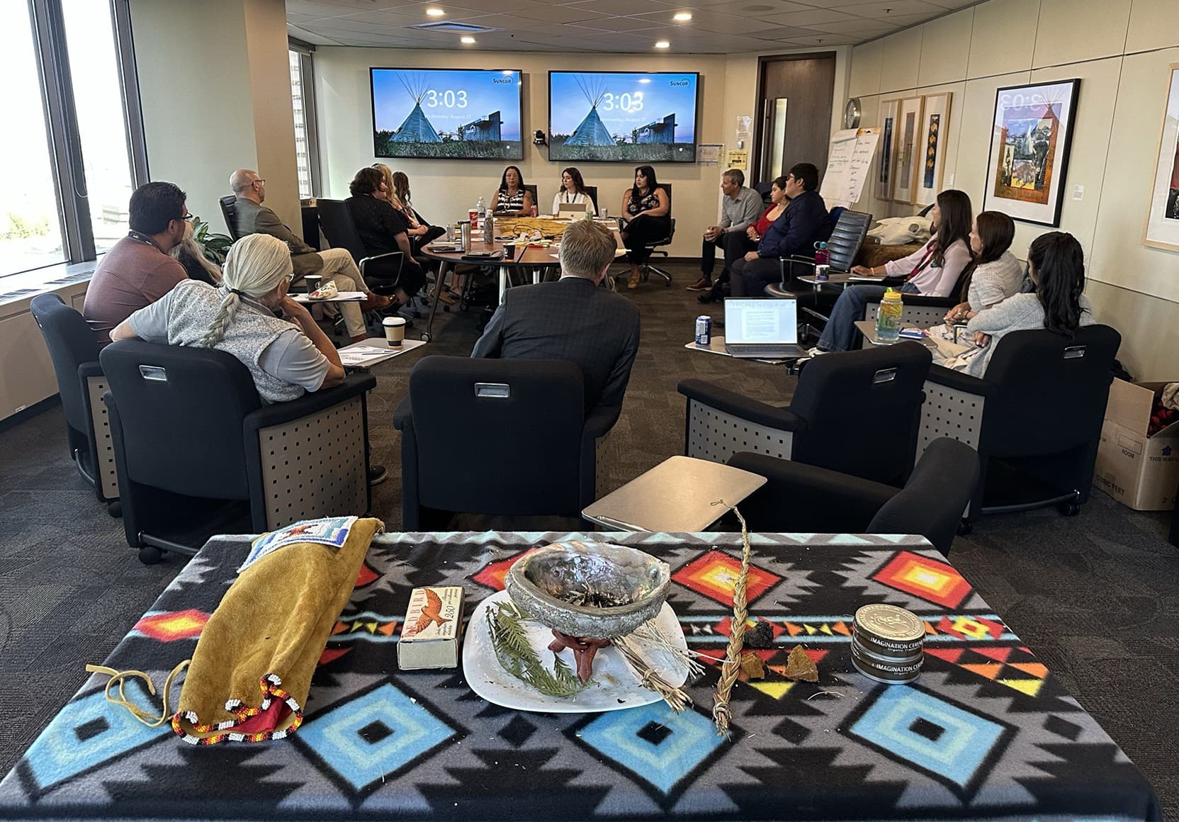 Indigenous community members and Suncor employees participate in a smudge ceremony at the Suncor Energy Centre.